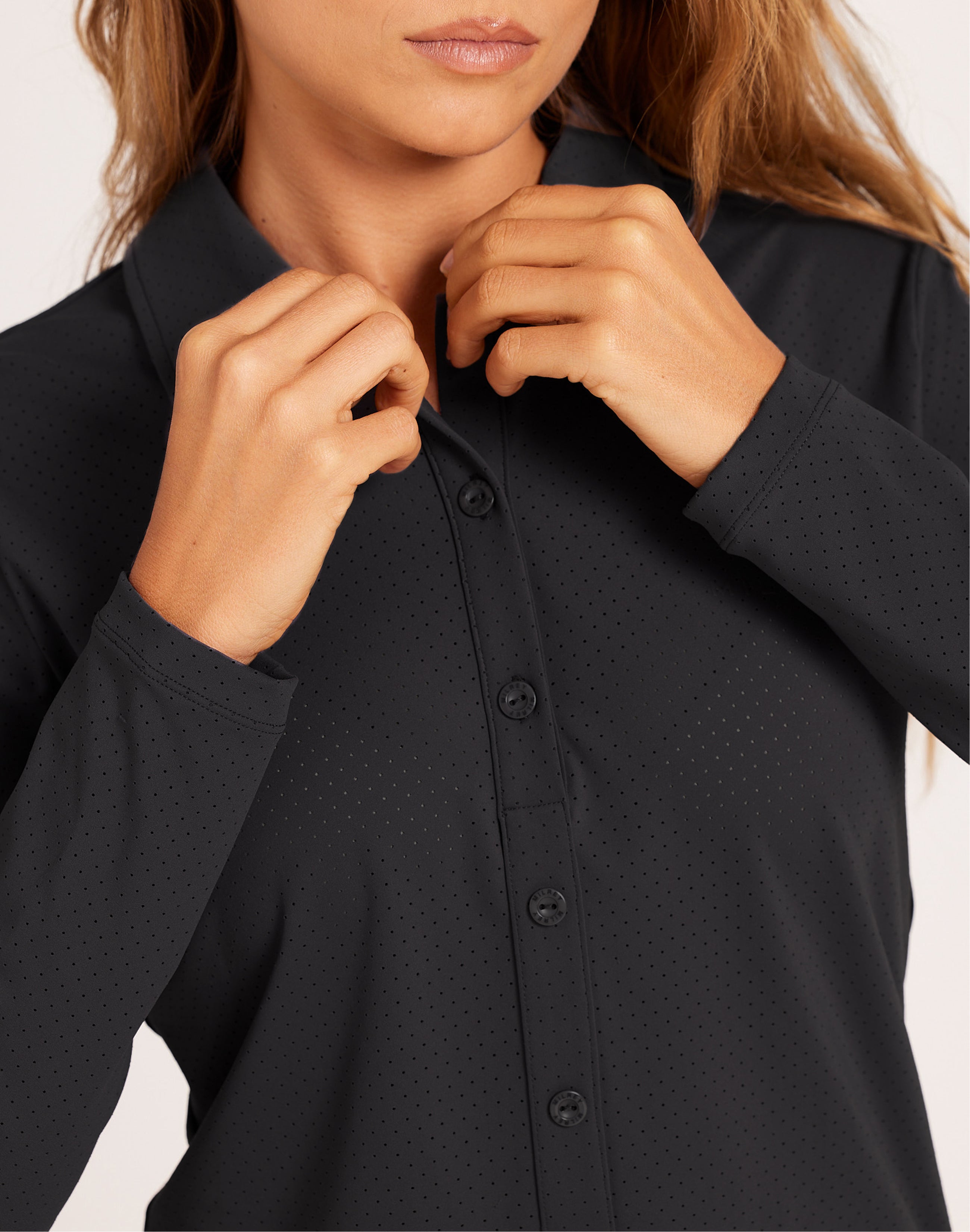 Milrey Callie long sleeve riding blouse in black, worn by a model — technical equestrian polo blouse.