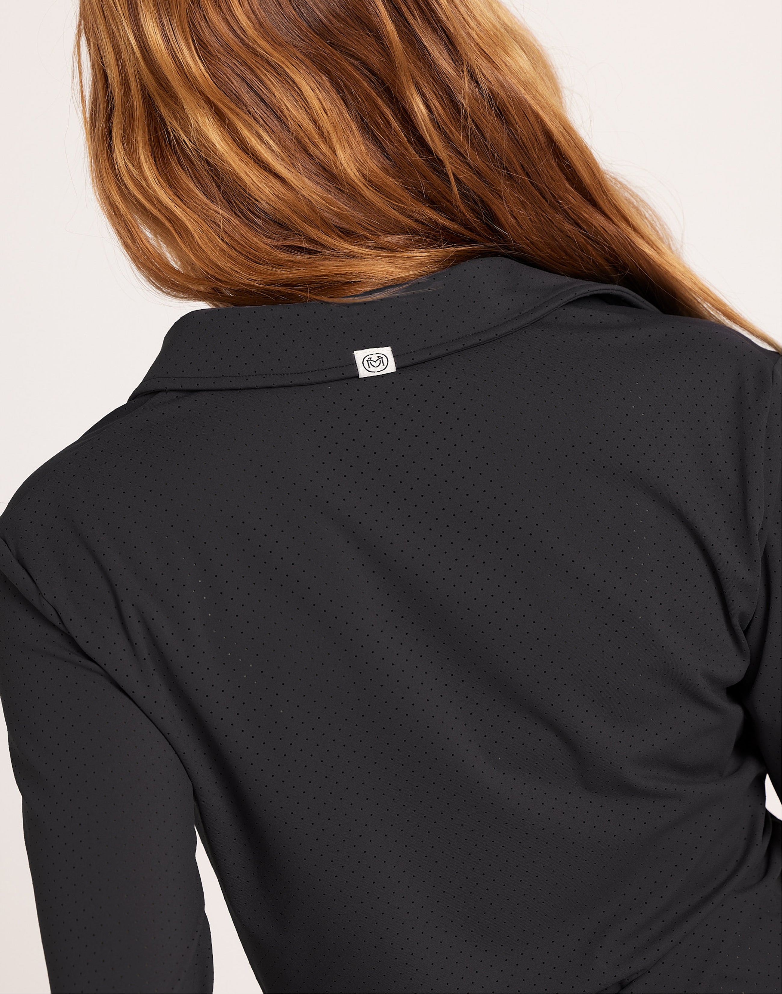 Milrey Callie long sleeve riding blouse in black — detail of discreet perforation and buttons.