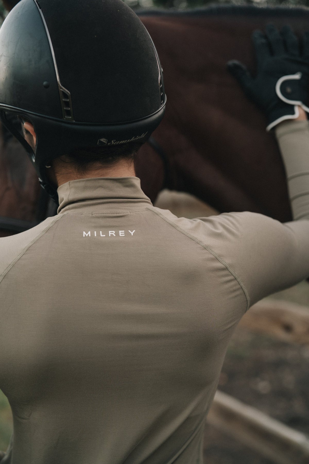 Back of the Mia Mock Neck in khaki showing the Milrey logo