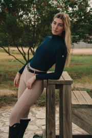 Navy Mia Mock Neck, side view leaning on a bench