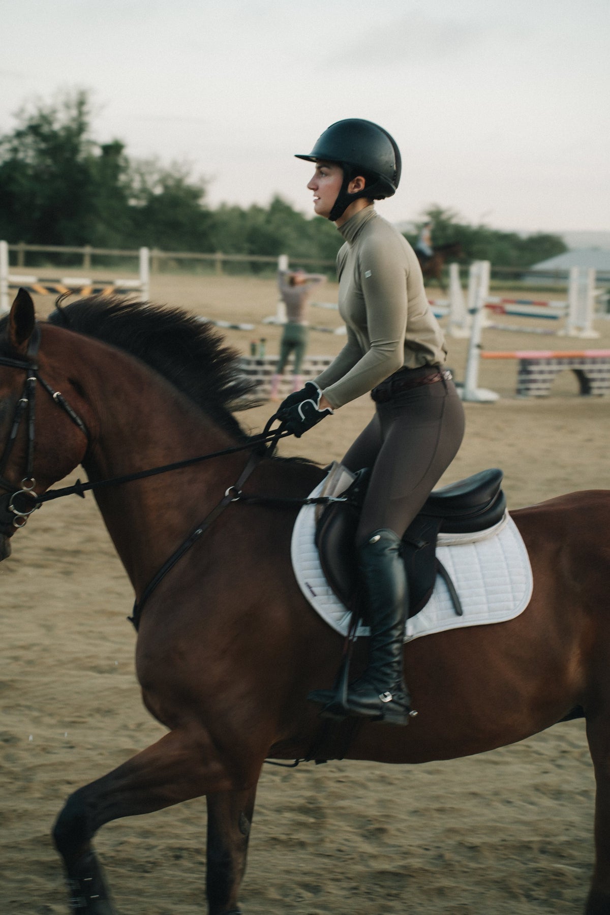 Khaki Mia Mock Neck in the saddle, side view