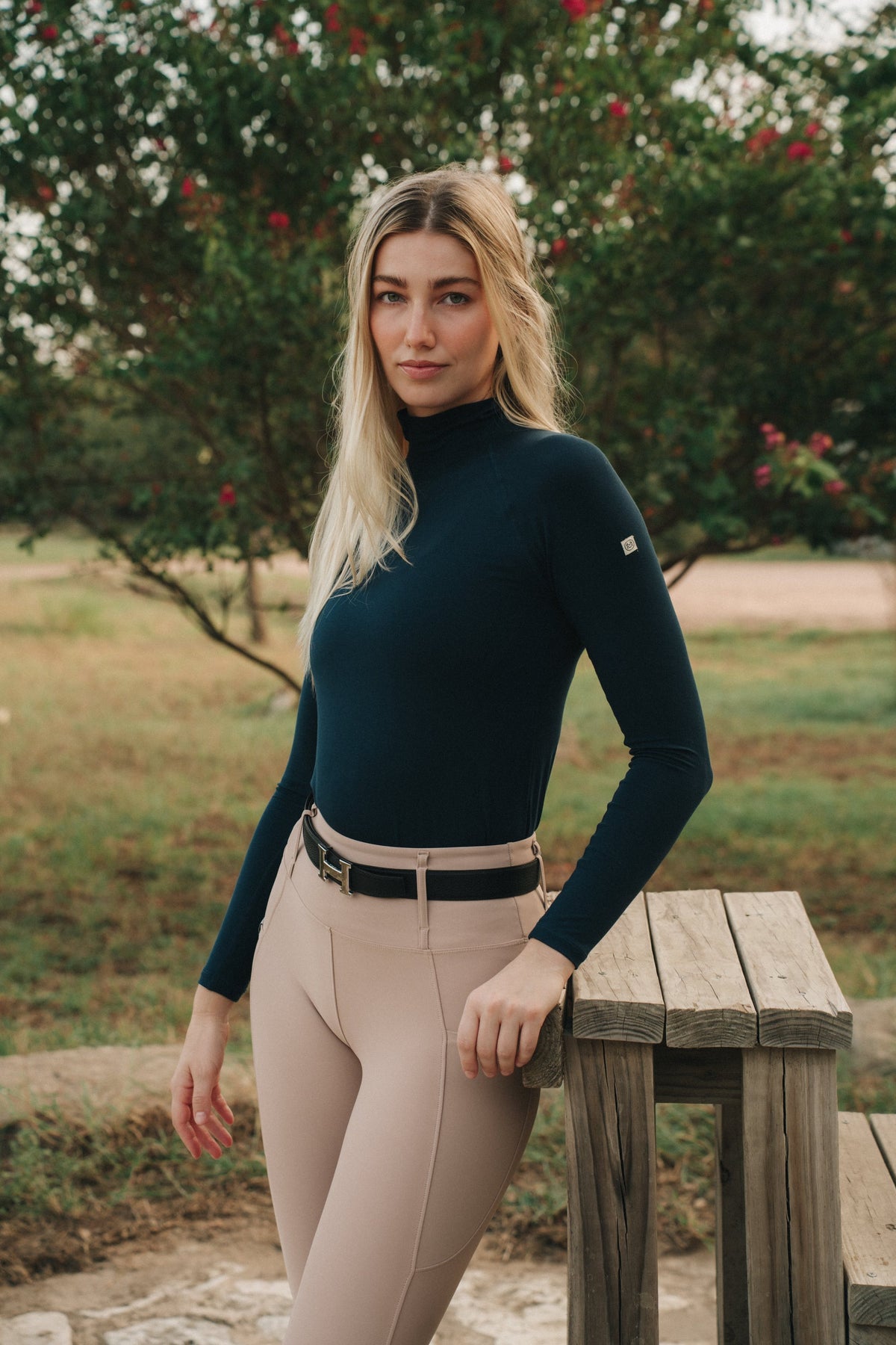 Rider wearing the Mia Mock Neck in navy, front view